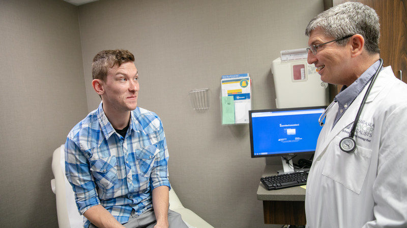 Oncologist Ralph Hauke, MD, tells Jake Arnold the good news that he's had his final PET scan.