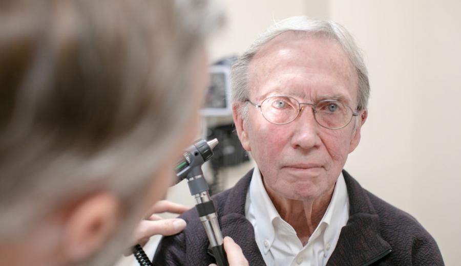 A Methodist provider examines the eyes of patient John Emery