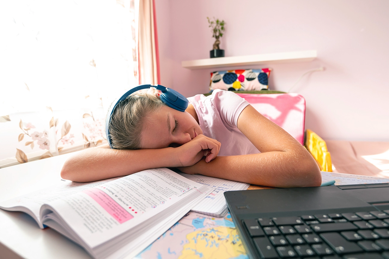 Young girl sleeping while studying