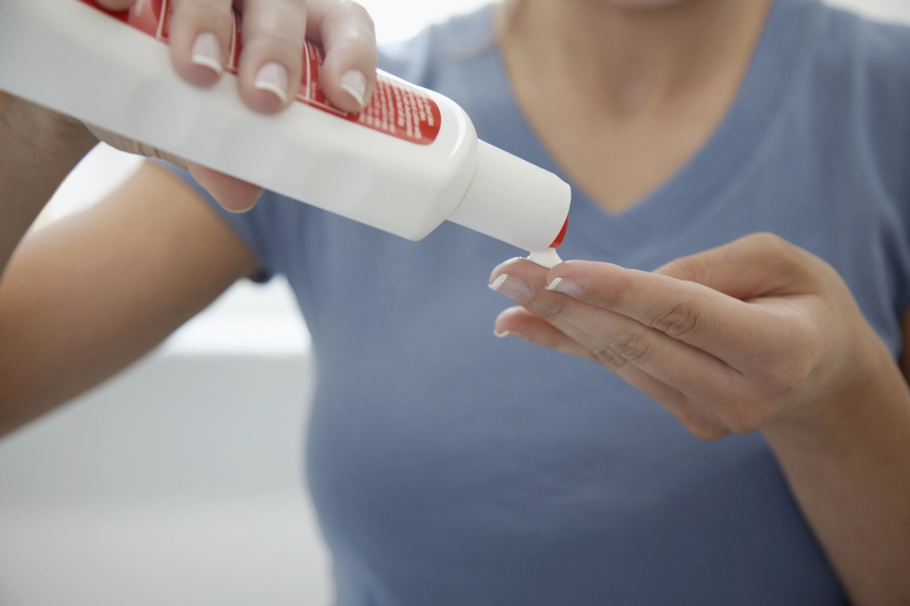 Woman putting on sunscreen