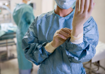 Image of a provider putting on medical gloves