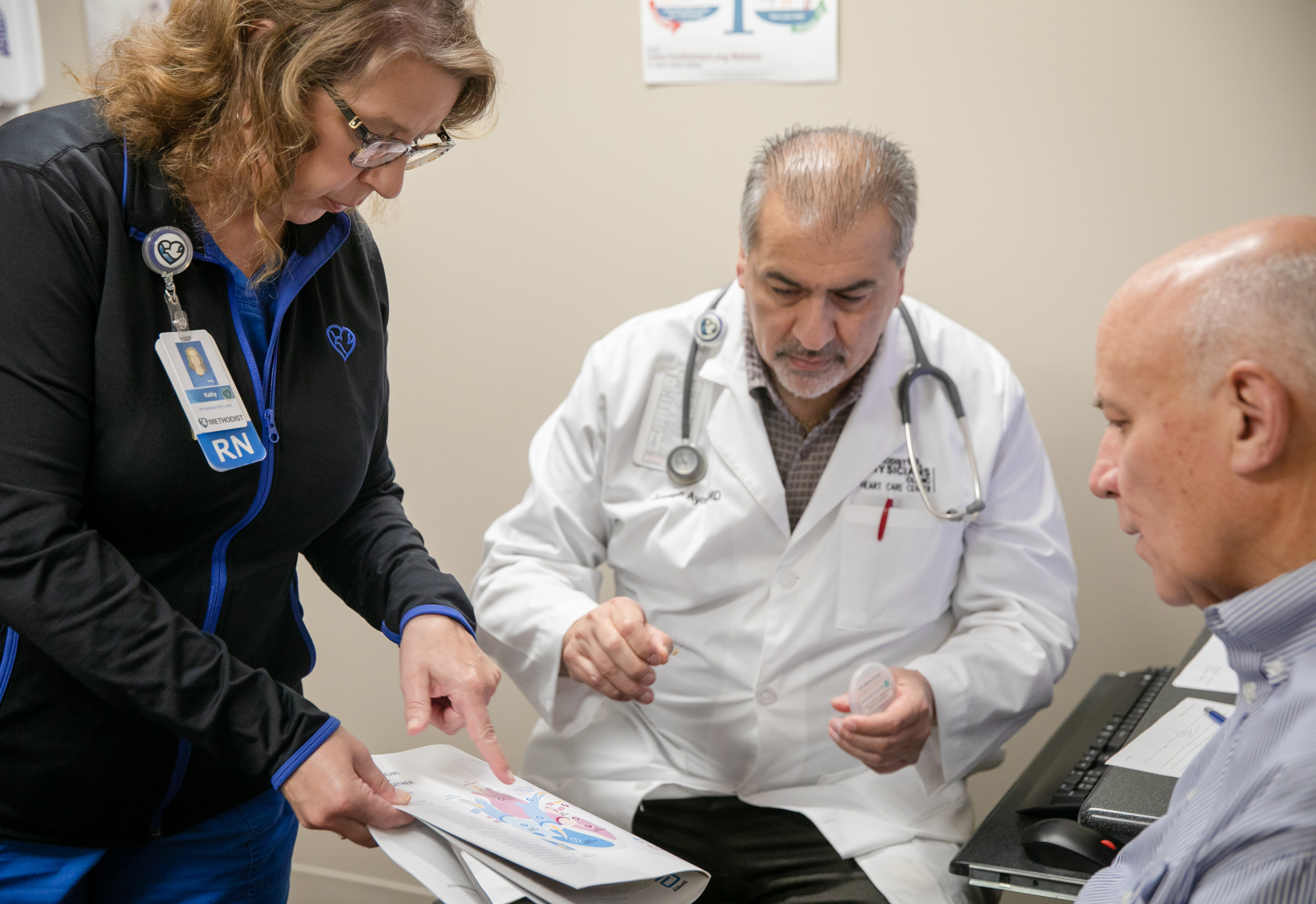 Kathy Sindelar, BSN, RN, and Joseph Ayoub, MD, meet with Tom Lowndes at a cardiology appointment 