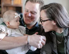 Photo of Sasha and Andrew Berscheid with their young child