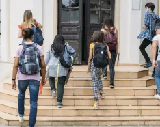 Teens walking into building
