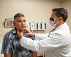 COVID-19 patient getting examined by physician