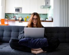 Woman working from home on couch