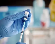 Worker prepares syringe