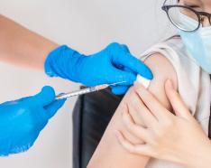Teen receiving COVID-19 vaccine