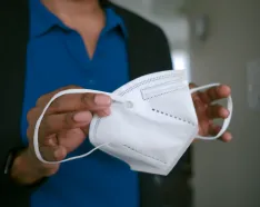 Image of a healthcare provider holding a KN95 mask