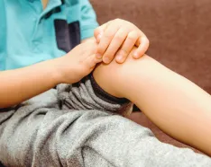 Child holding knee