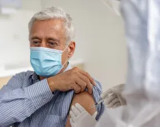 Older man receiving COVID-10 booster