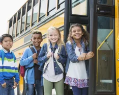 Kids getting on school bus