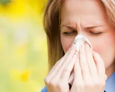 Woman blowing nose