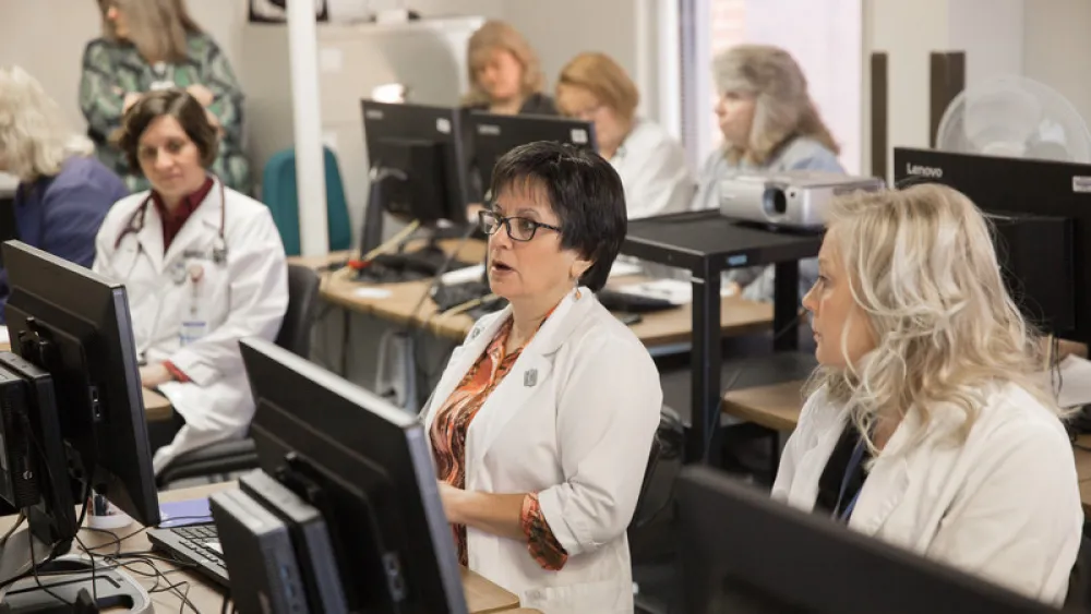 Photo of medical providers discussing an issue