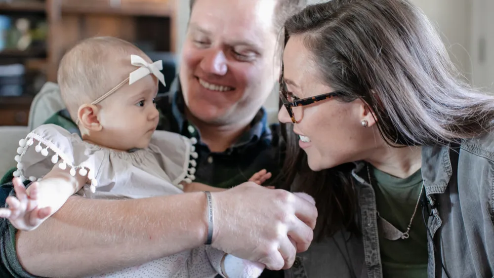 Photo of Sasha and Andrew Berscheid with their young child