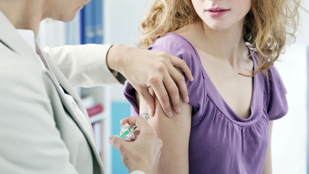 Teen getting HPV vaccine