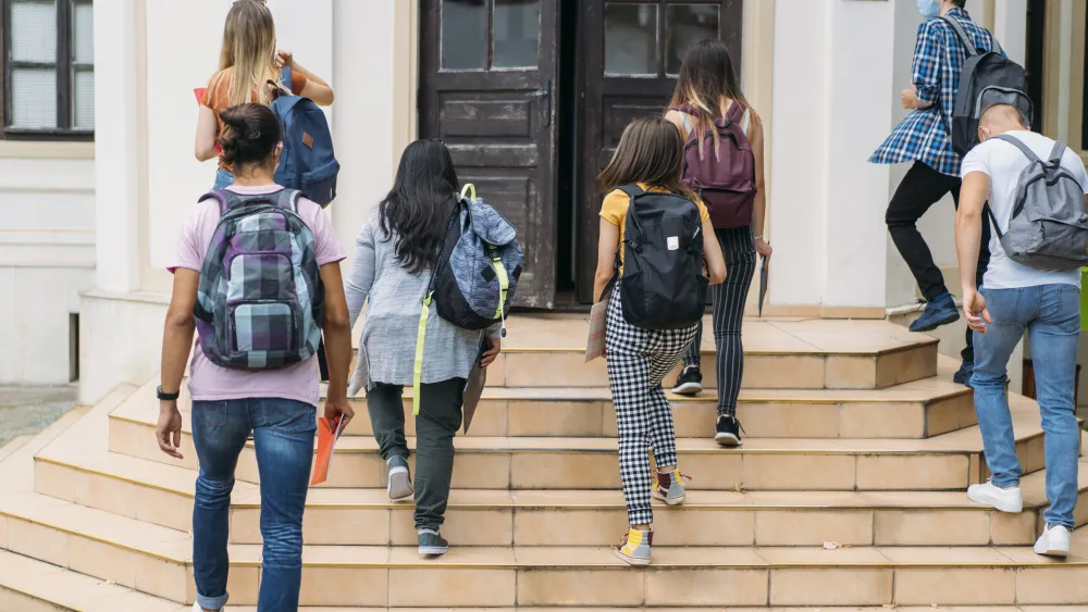 Teens walking into building