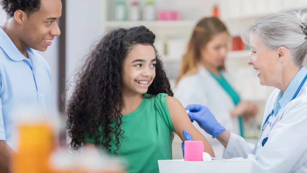 Preteen getting vaccinated