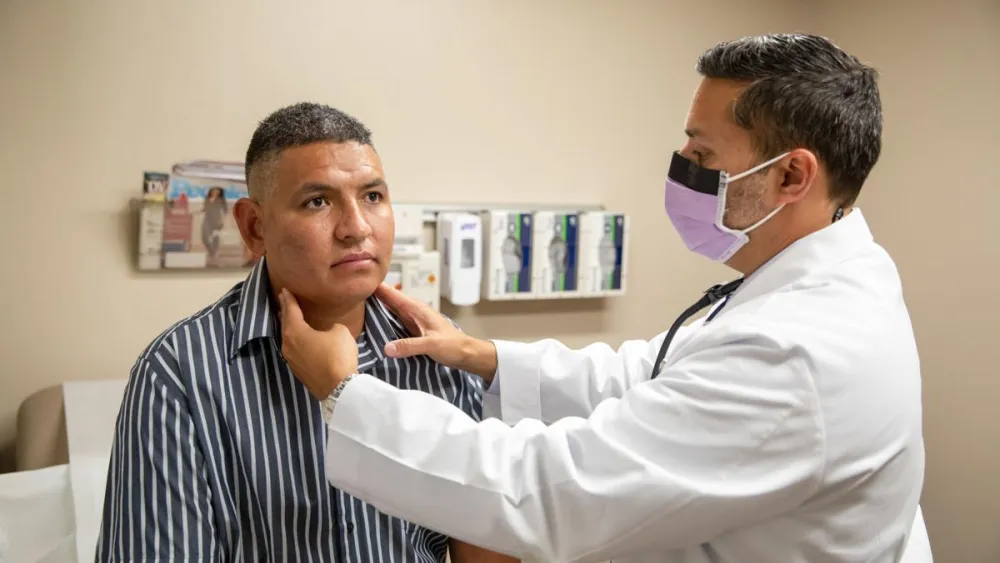 COVID-19 patient getting examined by physician