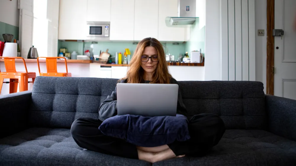 Woman working from home on couch