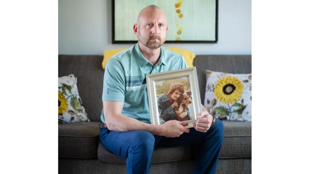 Matt Cooper with a photo of his mother, Michele