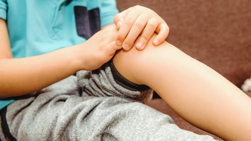 Child holding knee