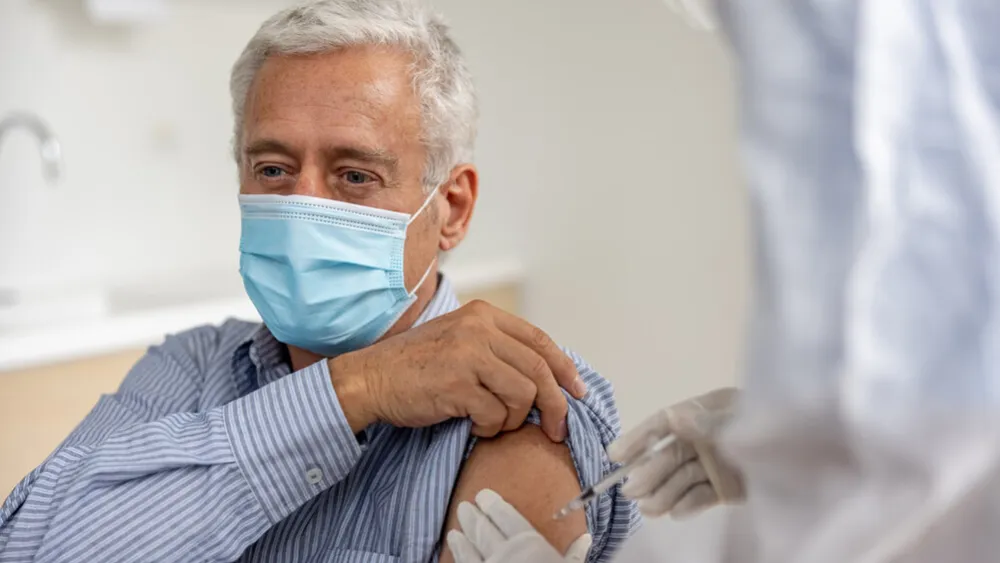 Older man receiving COVID-10 booster