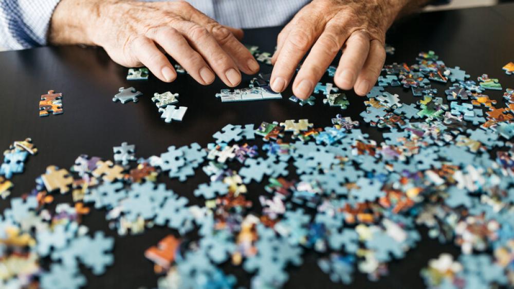 Older man working on puzzle