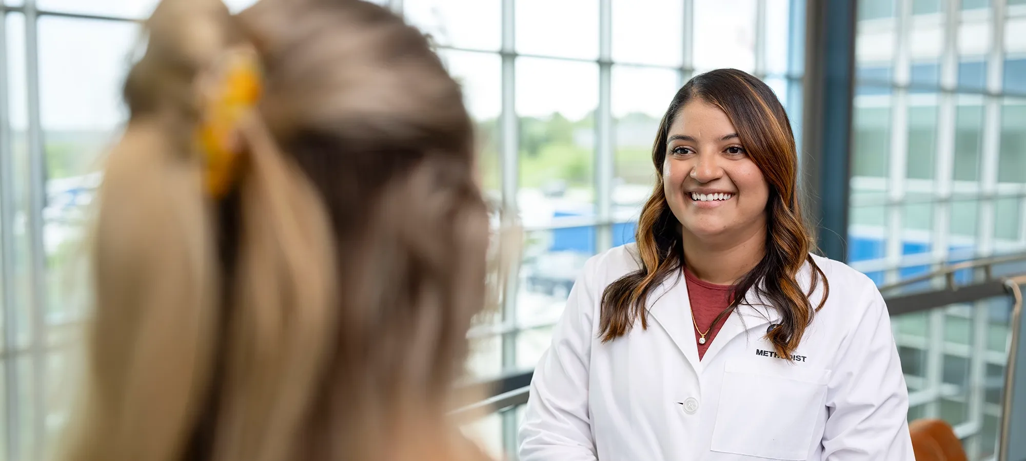 Photo of Dr. Reyes interacting with a patient.