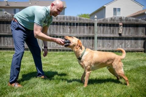 Matt Cooper plays with his dog, Berkeley, at his Omaha home. 