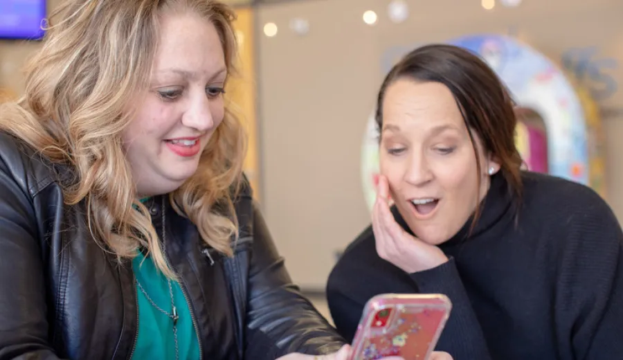 JoAnn Jensen shows Dr. Lori Platt a picture on her phone