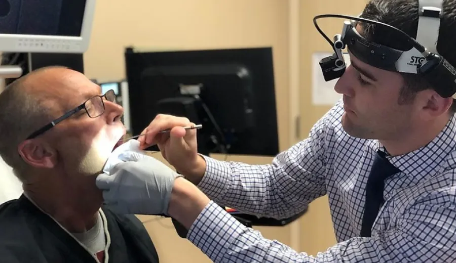 Mark Schmidt gets his throat looked at