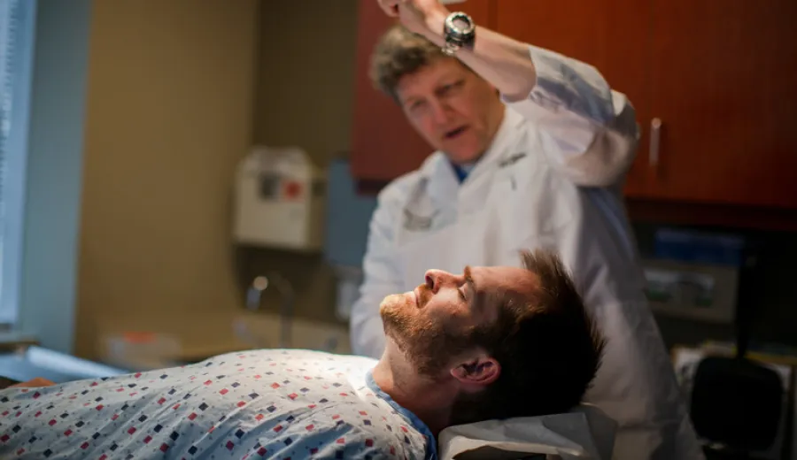 Doctor checking patients skin with light