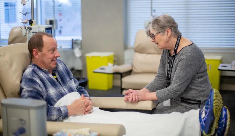 Tom Millsap talks with oncology research nurse navigator Marlene Watson, RN, BN, OCN